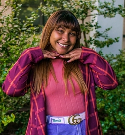 Female smiling with her hands flat under her chin